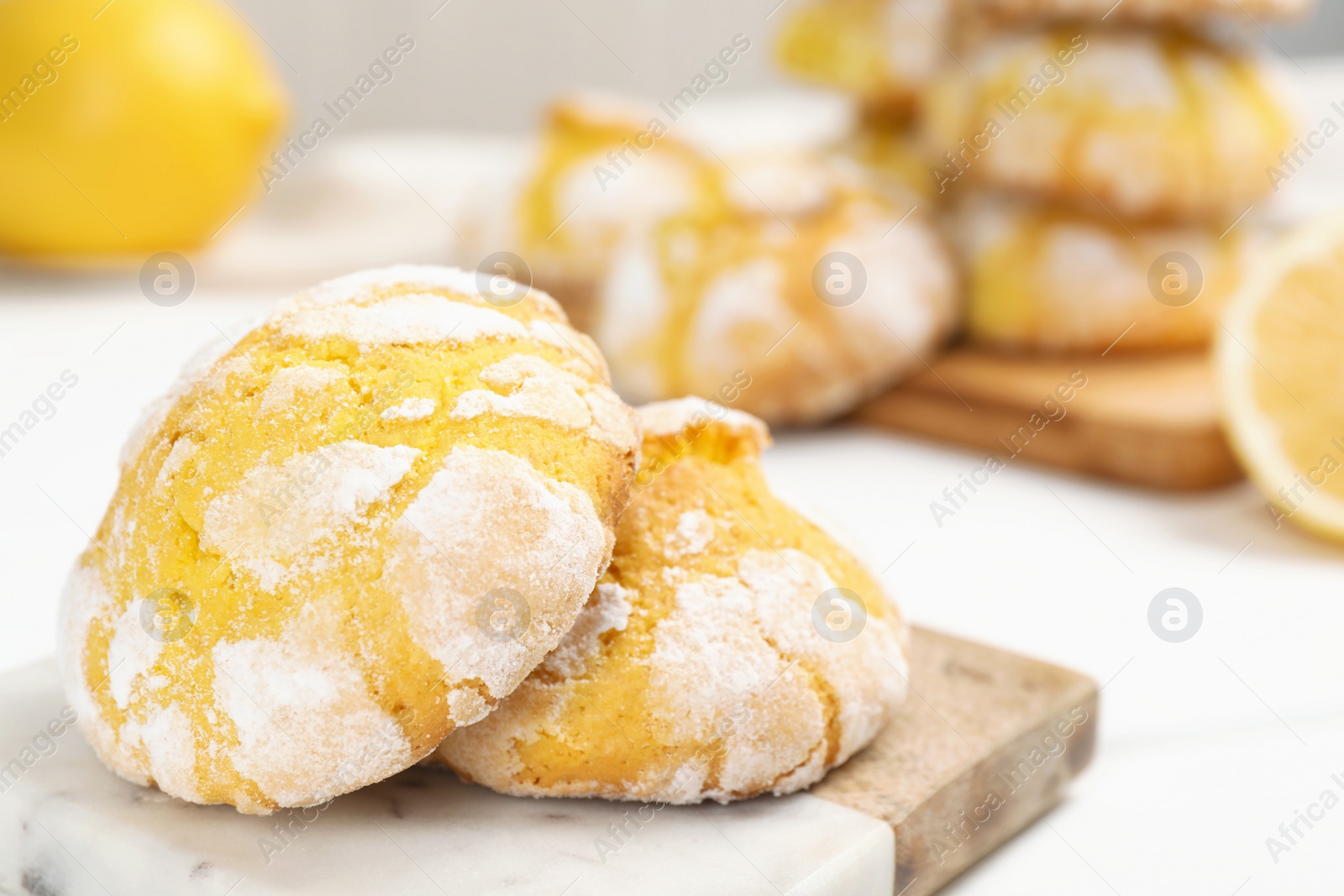 Photo of Tasty homemade lemon cookies on white table, closeup. Space for text