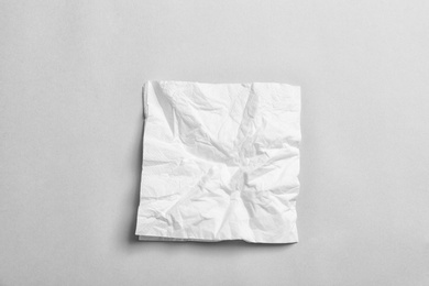 Crumpled napkin on grey background, top view. Personal hygiene