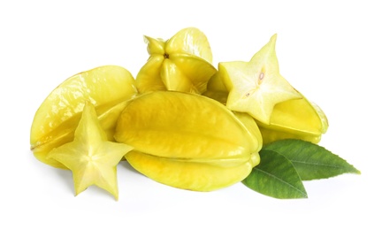 Photo of Cut and whole carambolas with green leaves on white background