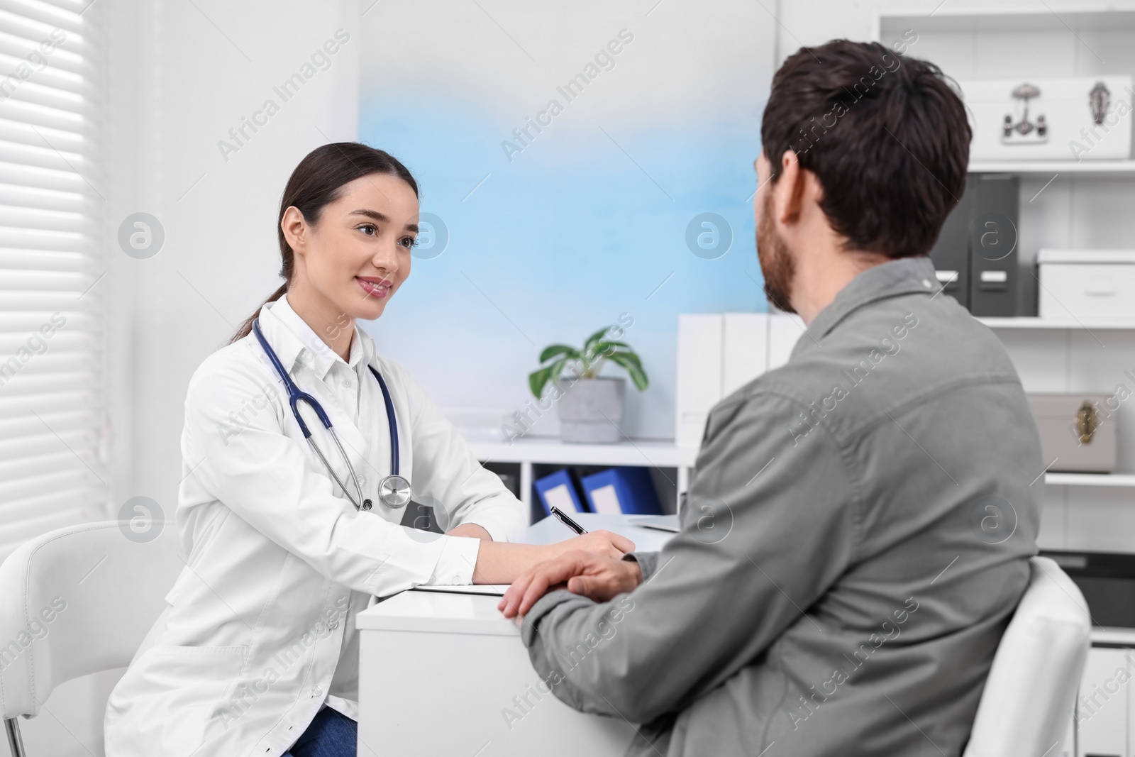 Photo of Doctor consulting patient during appointment in clinic