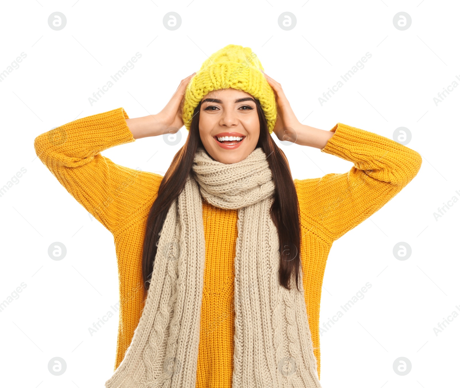 Photo of Happy young woman in warm clothes on white background. Winter vacation