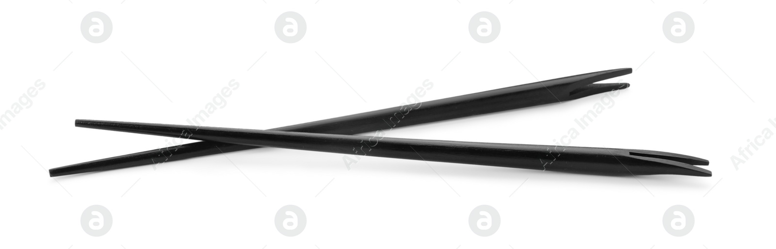 Photo of Pair of black chopsticks isolated on white