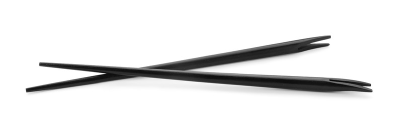 Photo of Pair of black chopsticks isolated on white