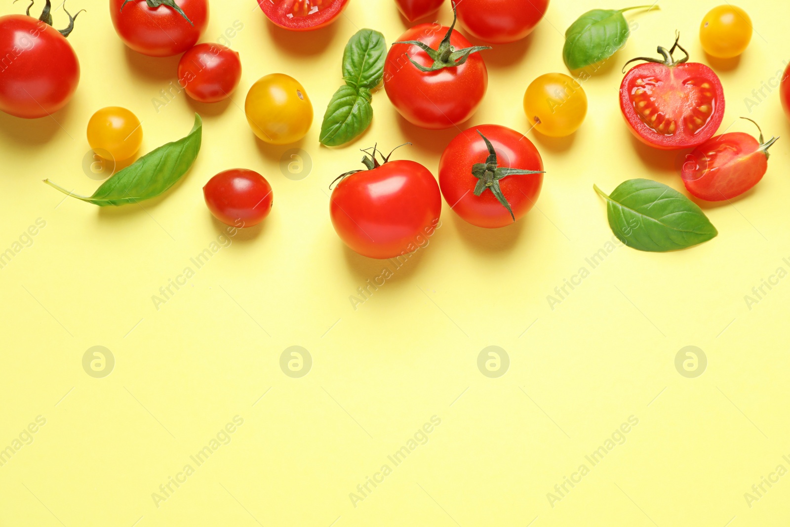 Photo of Flat lay composition with cherry tomatoes on color background. Space for text