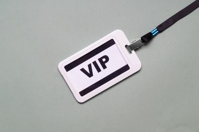 Plastic vip badge on light gray background, top view