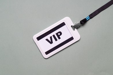 Photo of Plastic vip badge on light gray background, top view