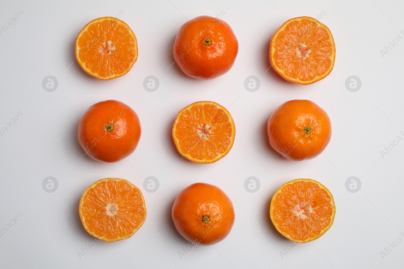 Photo of Delicious tangerines on white background, flat lay