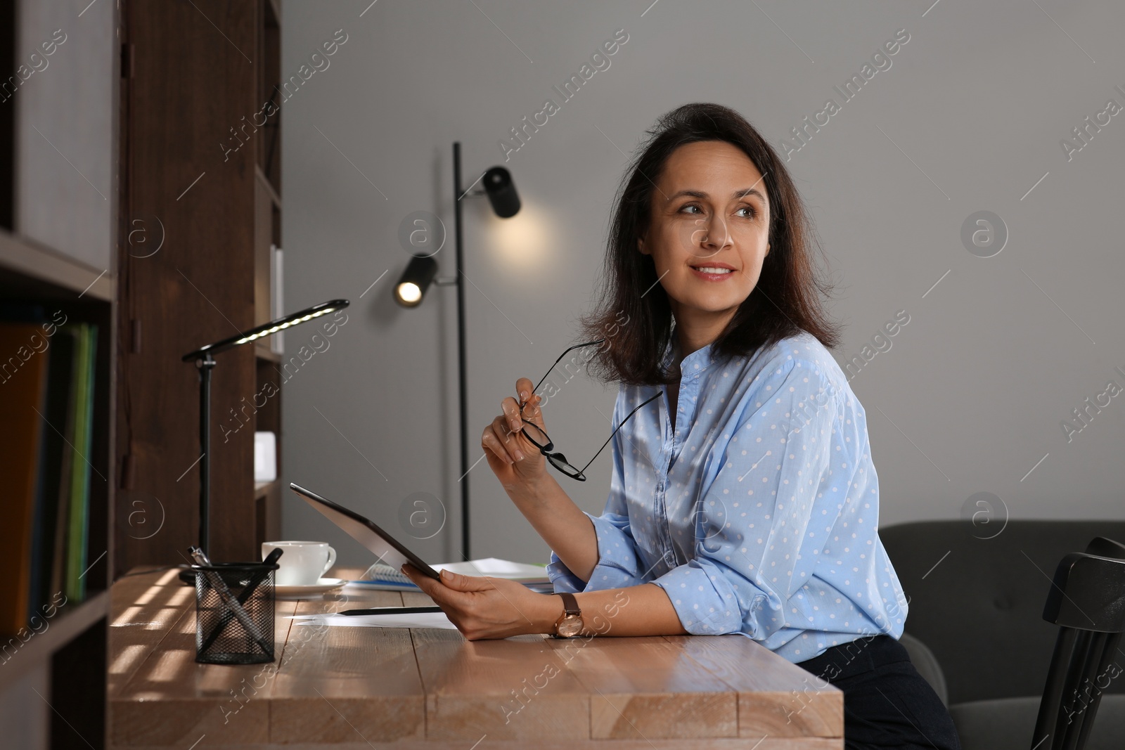 Photo of Woman with modern tablet learning at table indoors