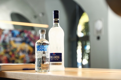 MYKOLAIV, UKRAINE - SEPTEMBER 23, 2019: Bottles of Finlandia and Absolut vodka on wooden counter in bar