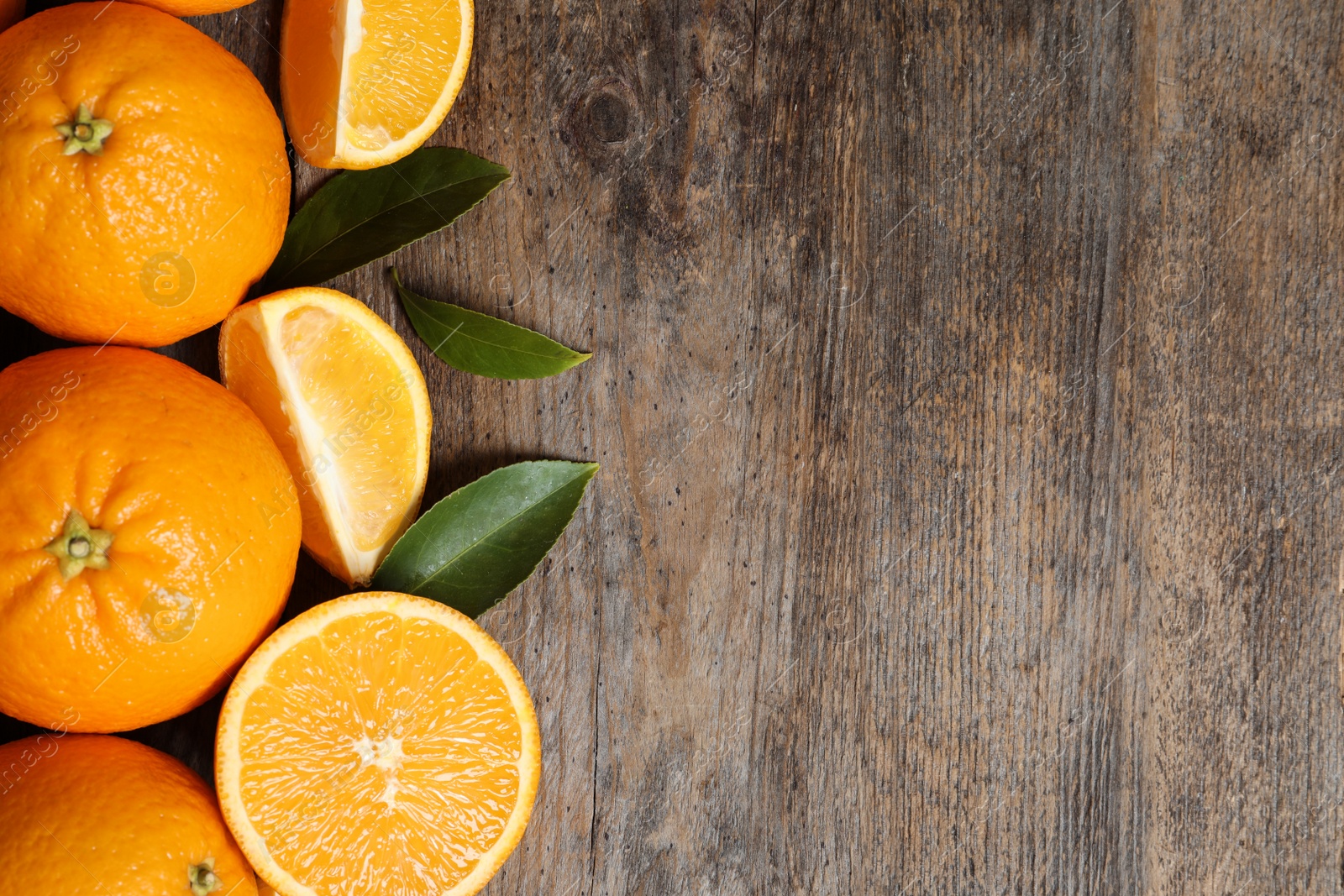 Photo of Flat lay composition with ripe oranges and space for text on wooden background