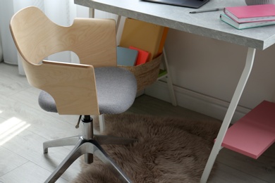 Photo of Comfortable workplace with office chair and modern table