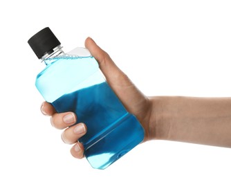 Woman holding bottle with mouthwash for teeth care on white background, closeup