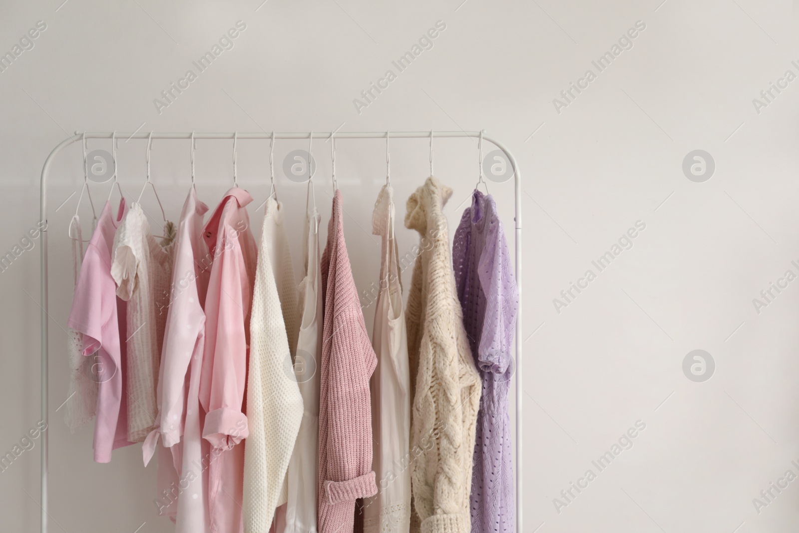 Photo of Rack with stylish women's clothes indoors, space for text. Interior design