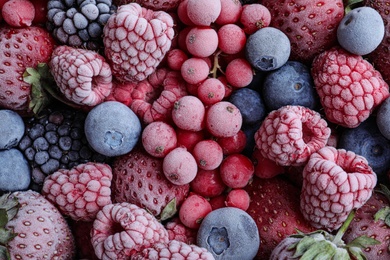 Mix of different frozen berries as background, top view