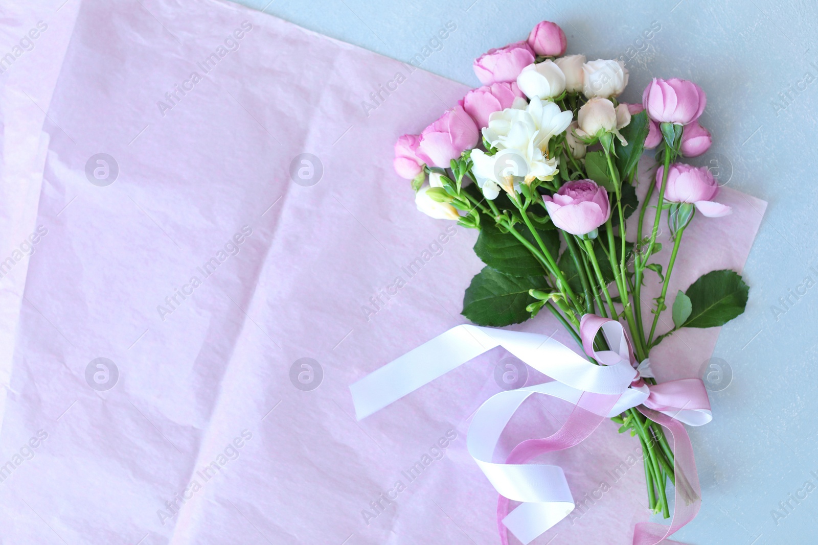 Photo of Bouquet of beautiful flowers on grey background, top view