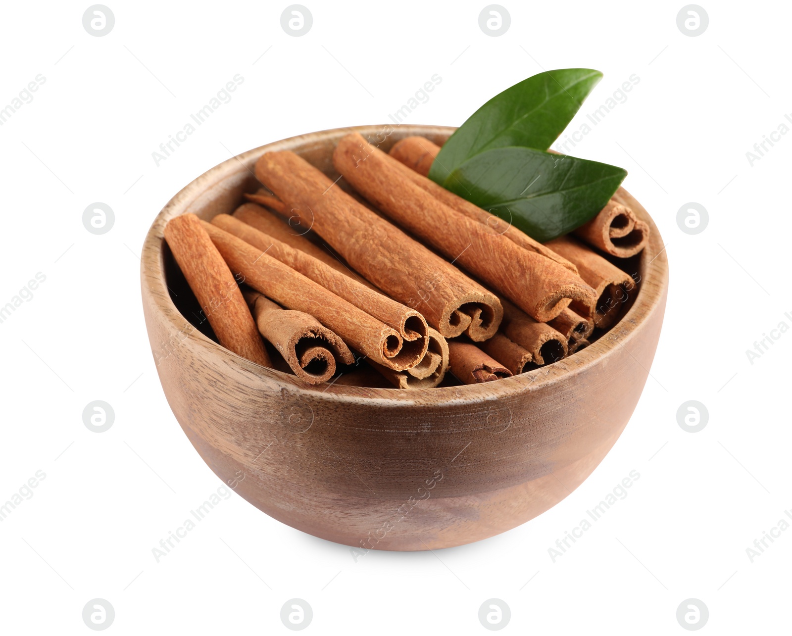 Photo of Cinnamon sticks and green leaves in bowl isolated on white