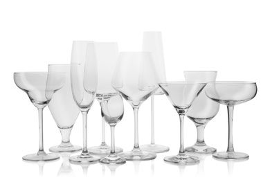 Photo of Set of empty glasses for different drinks on white background