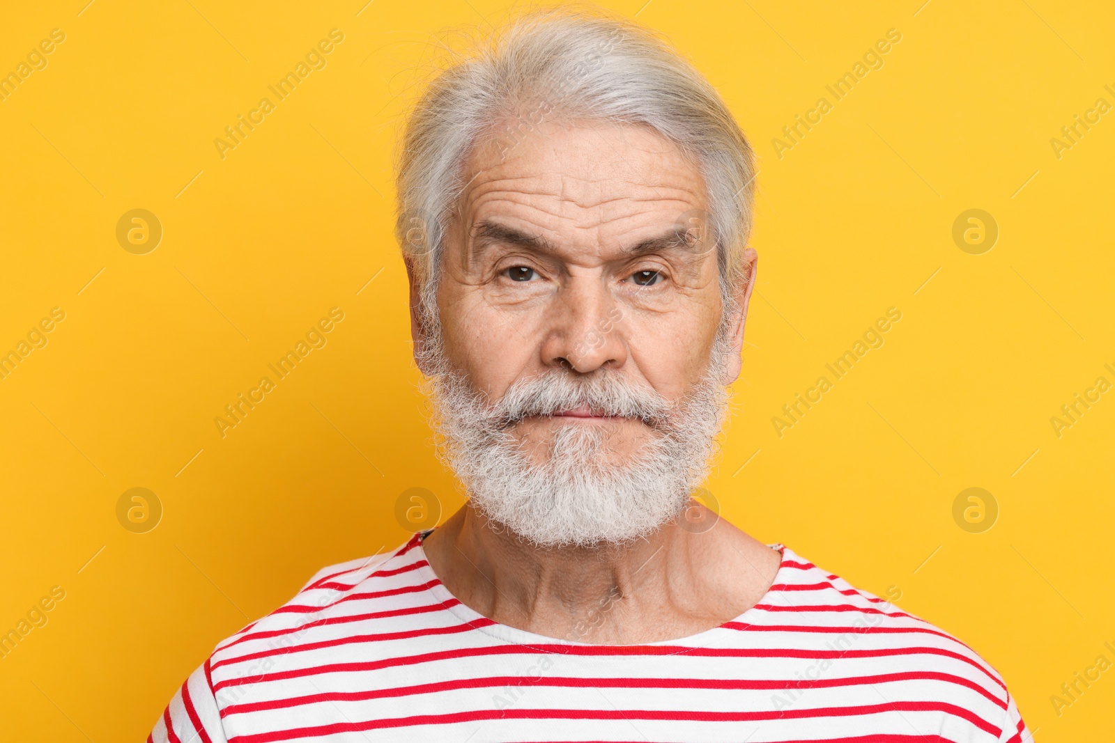 Photo of Senior man with mustache on orange background