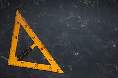 Photo of Triangle with measuring length markings on blackboard, top view. Space for text