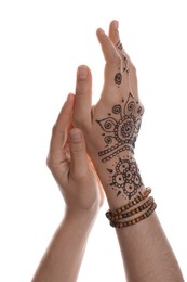 Woman with beautiful henna tattoo on hand against white background, closeup. Traditional mehndi