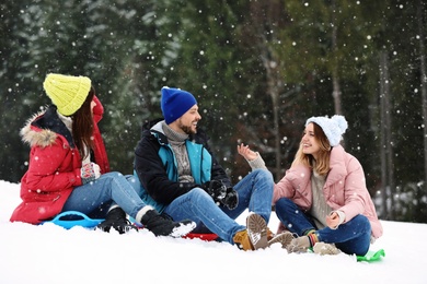 Photo of People with plastic sleds outdoors. Winter vacation