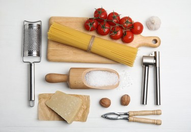 Photo of Cooking utensils and ingredients on white wooden table, flat lay