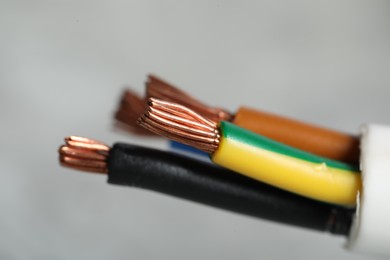 Photo of Colorful electrical wire on gray background, closeup