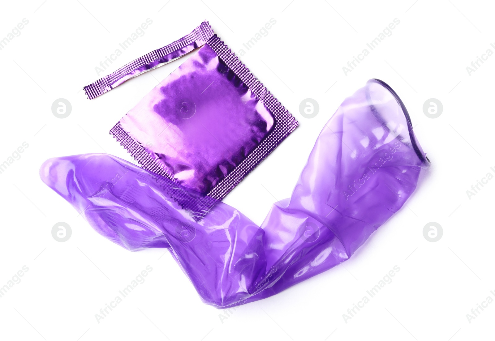 Image of Unrolled violet condom and package on white background. Safe sex