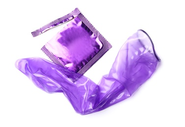 Unrolled violet condom and package on white background. Safe sex