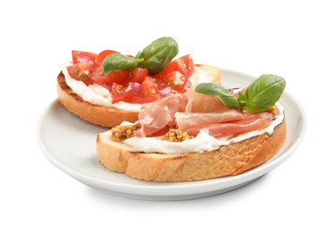 Photo of Plate with tasty bruschettas on white background