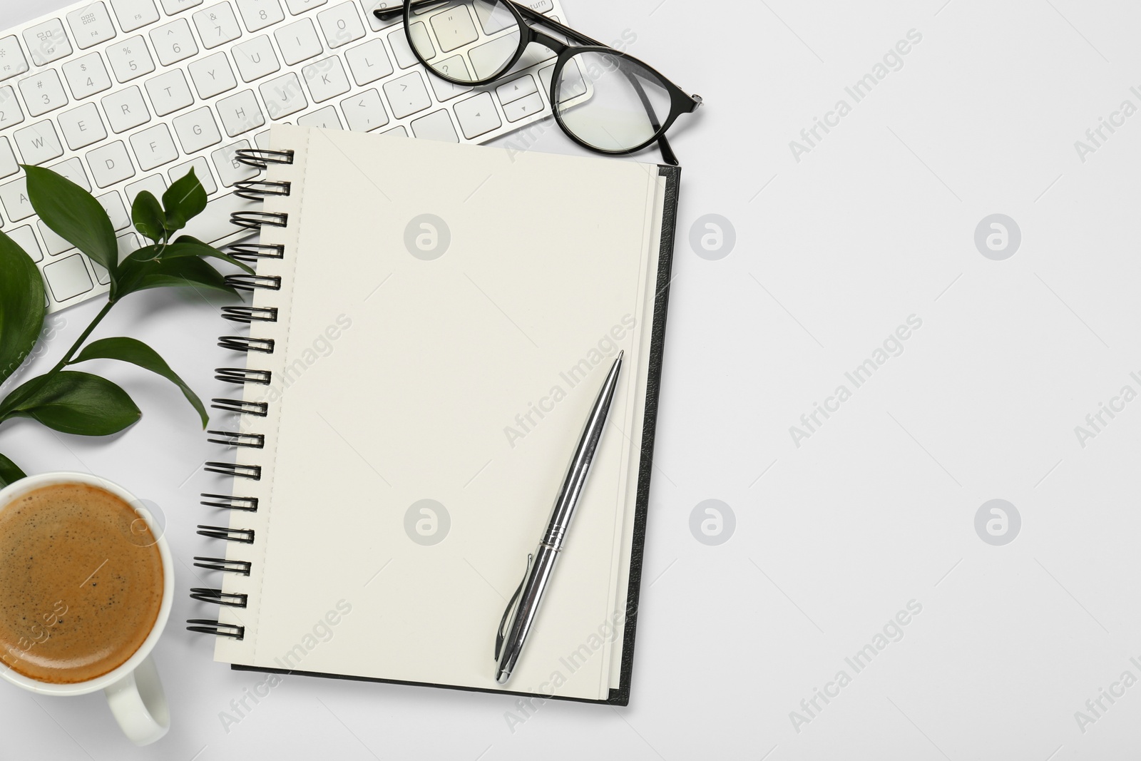 Photo of Flat lay composition with open notebook and coffee on white table