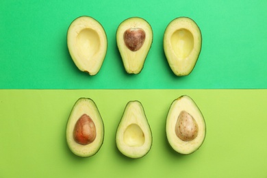 Flat lay composition with ripe avocados on color background