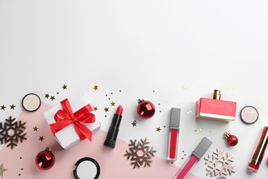 Photo of Flat lay composition with decorative cosmetic products on color background, space for text. Winter care