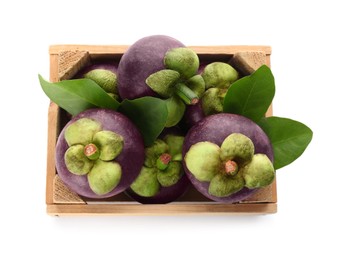 Photo of Fresh mangosteen fruits with green leaves in wooden crate on white background, top view