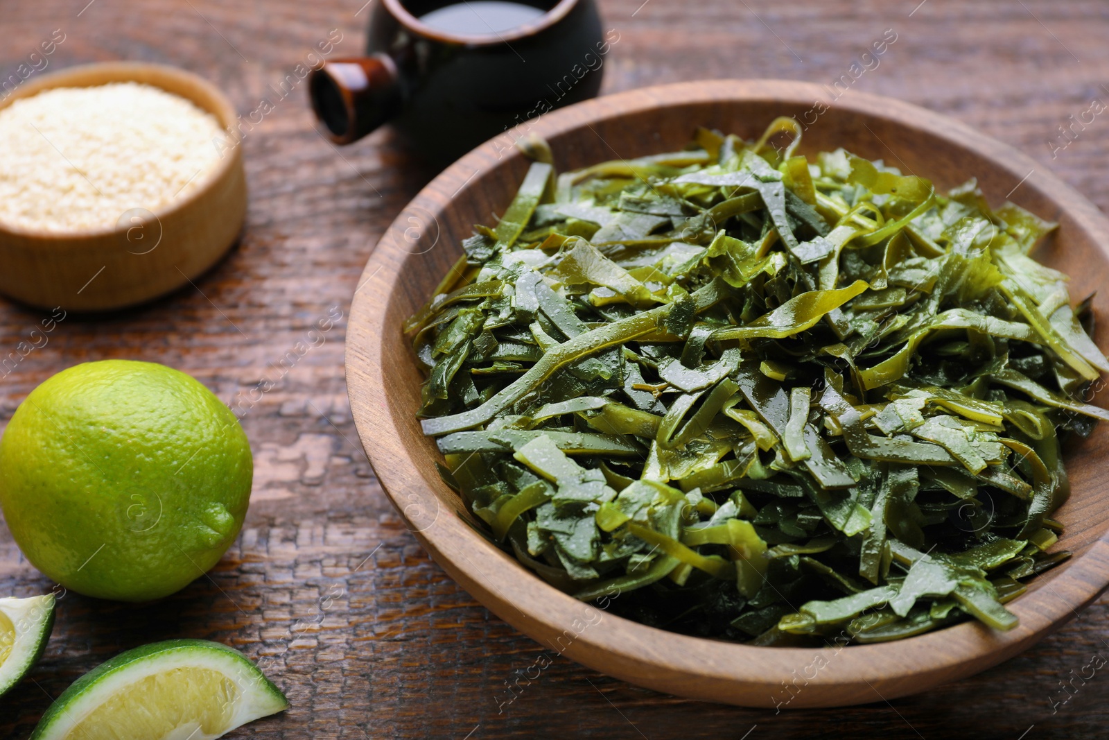 Photo of Fresh laminaria (kelp) seaweed served on wooden table