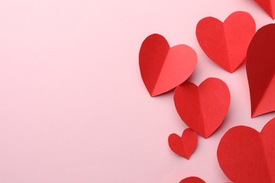 Photo of Paper hearts on pink background, flat lay. Space for text