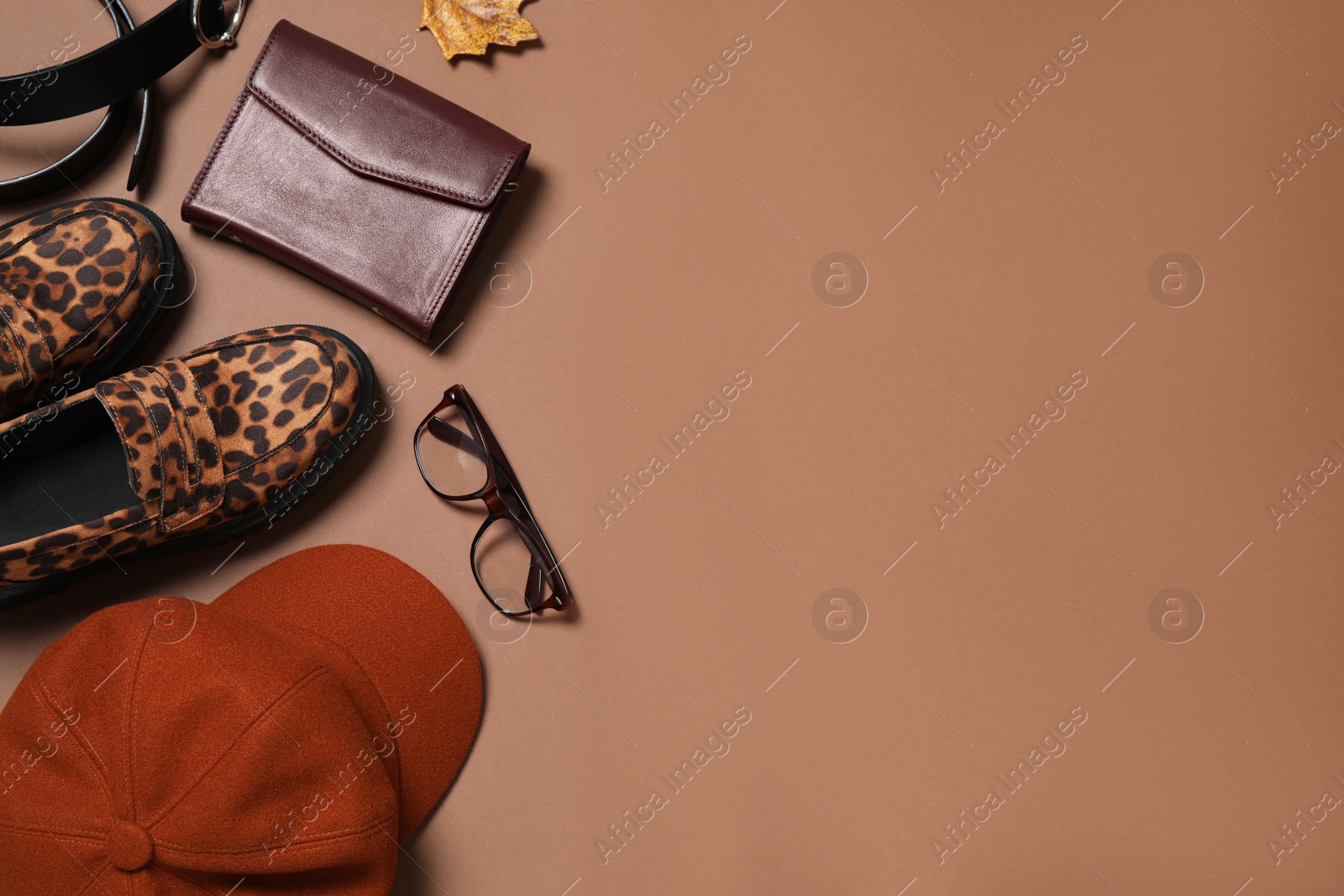 Photo of Flat lay composition with stylish hat on brown background, space for text