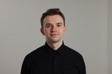 Photo of Portrait of handsome man on grey background