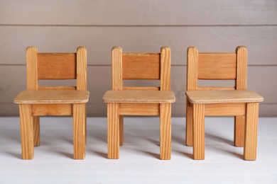 Small toy chairs on white wooden table