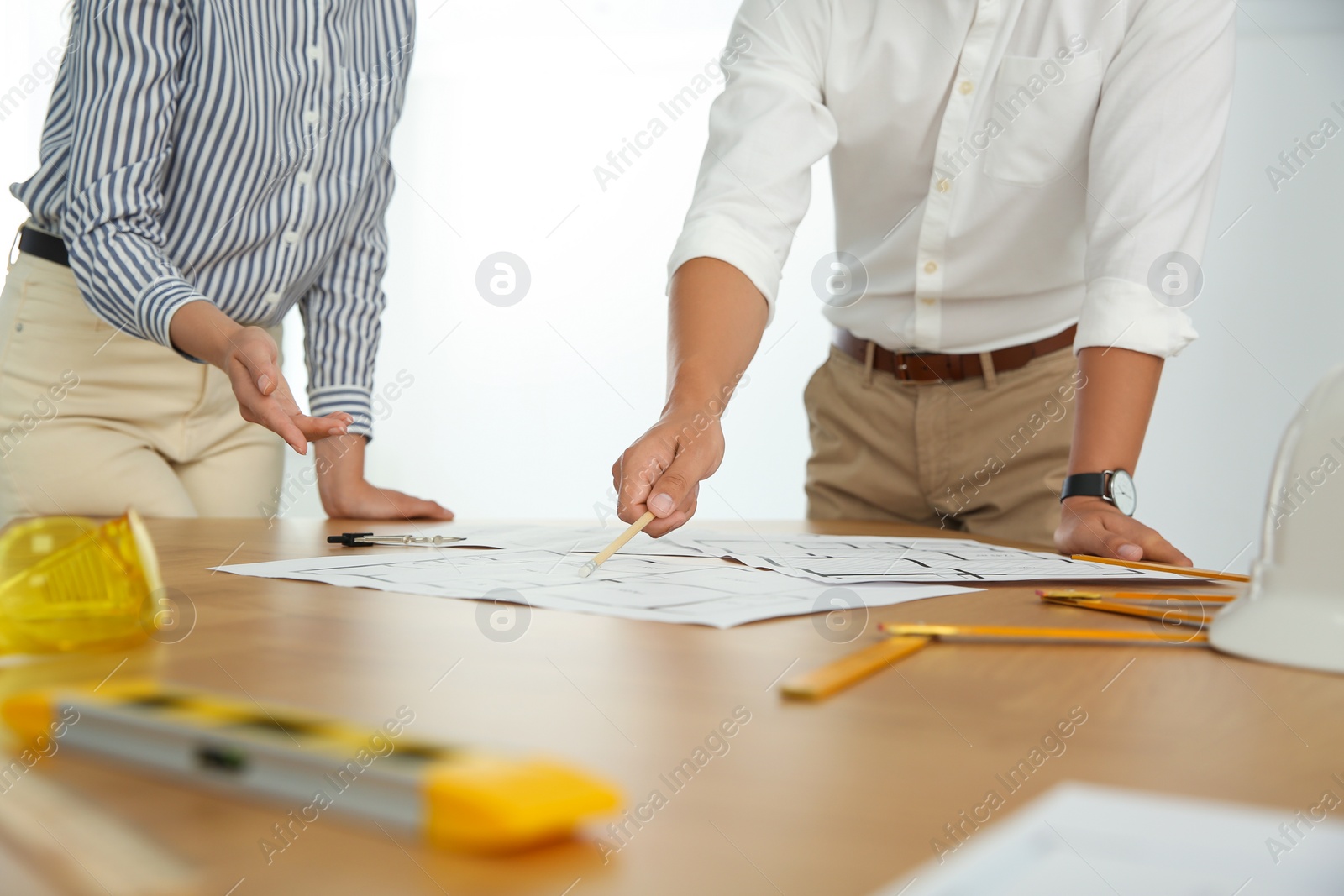 Photo of People working with construction drawings at table, closeup