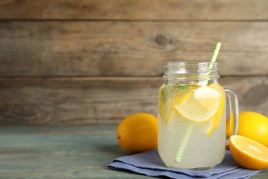 Cool freshly made lemonade and fruits on light blue wooden table. space for text