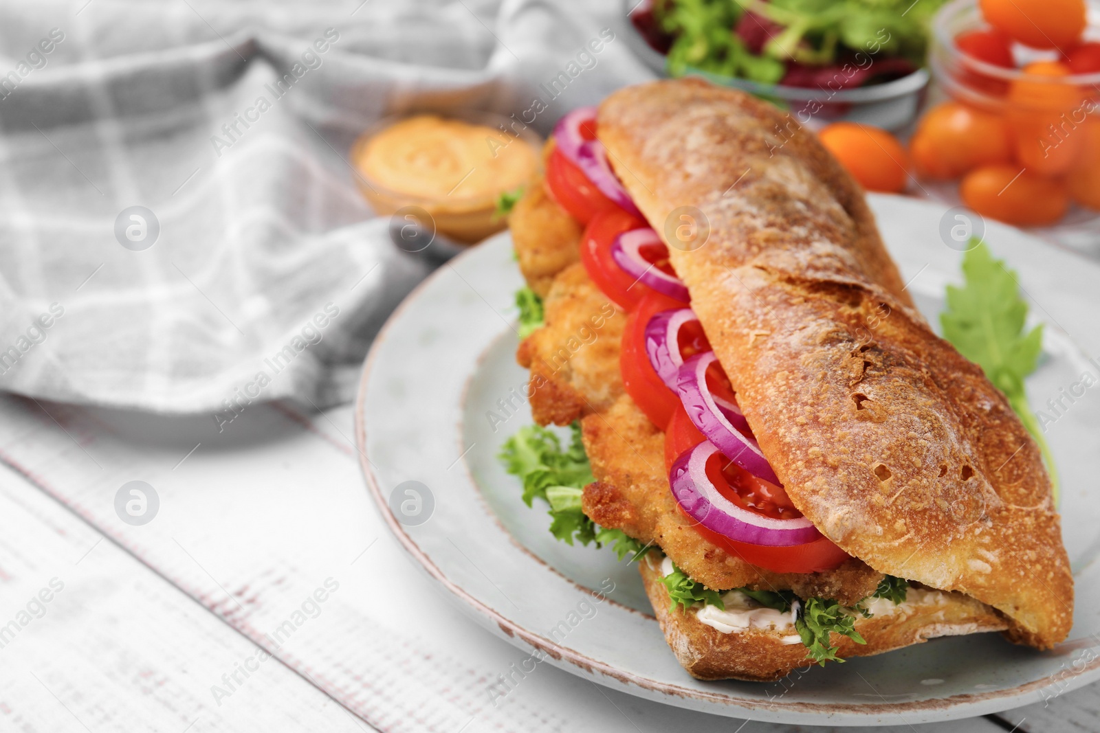 Photo of Delicious sandwich with schnitzel on white wooden table, space for text