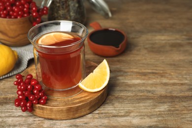 Immunity boosting drink and ingredients on wooden table, space for text