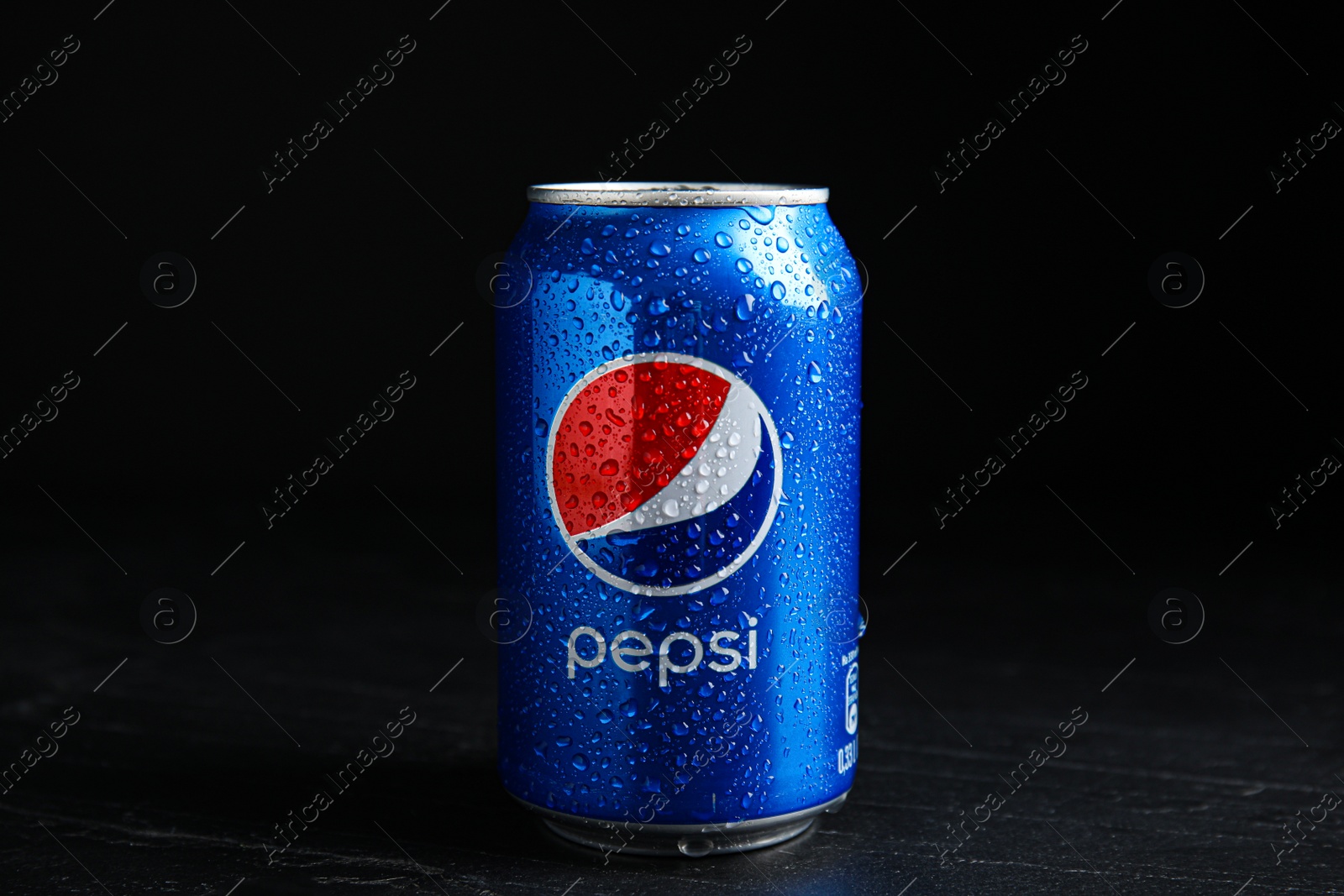Photo of MYKOLAIV, UKRAINE - FEBRUARY 08, 2021: Can of Pepsi with water drops on black table