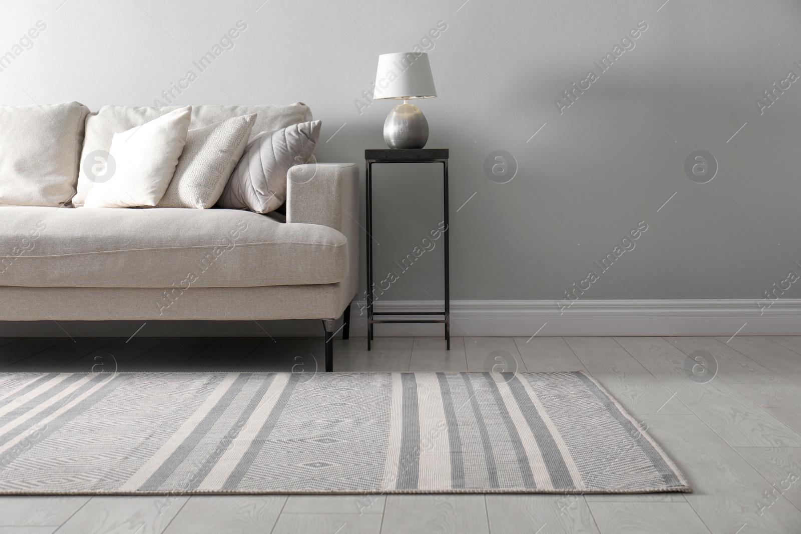 Photo of Living room interior with comfortable sofa and stylish rug