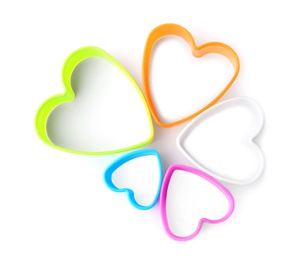 Photo of Heart shaped cookie cutters on white background, top view