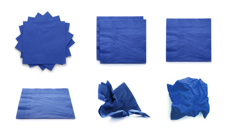 Image of Set with blue paper napkins on white background