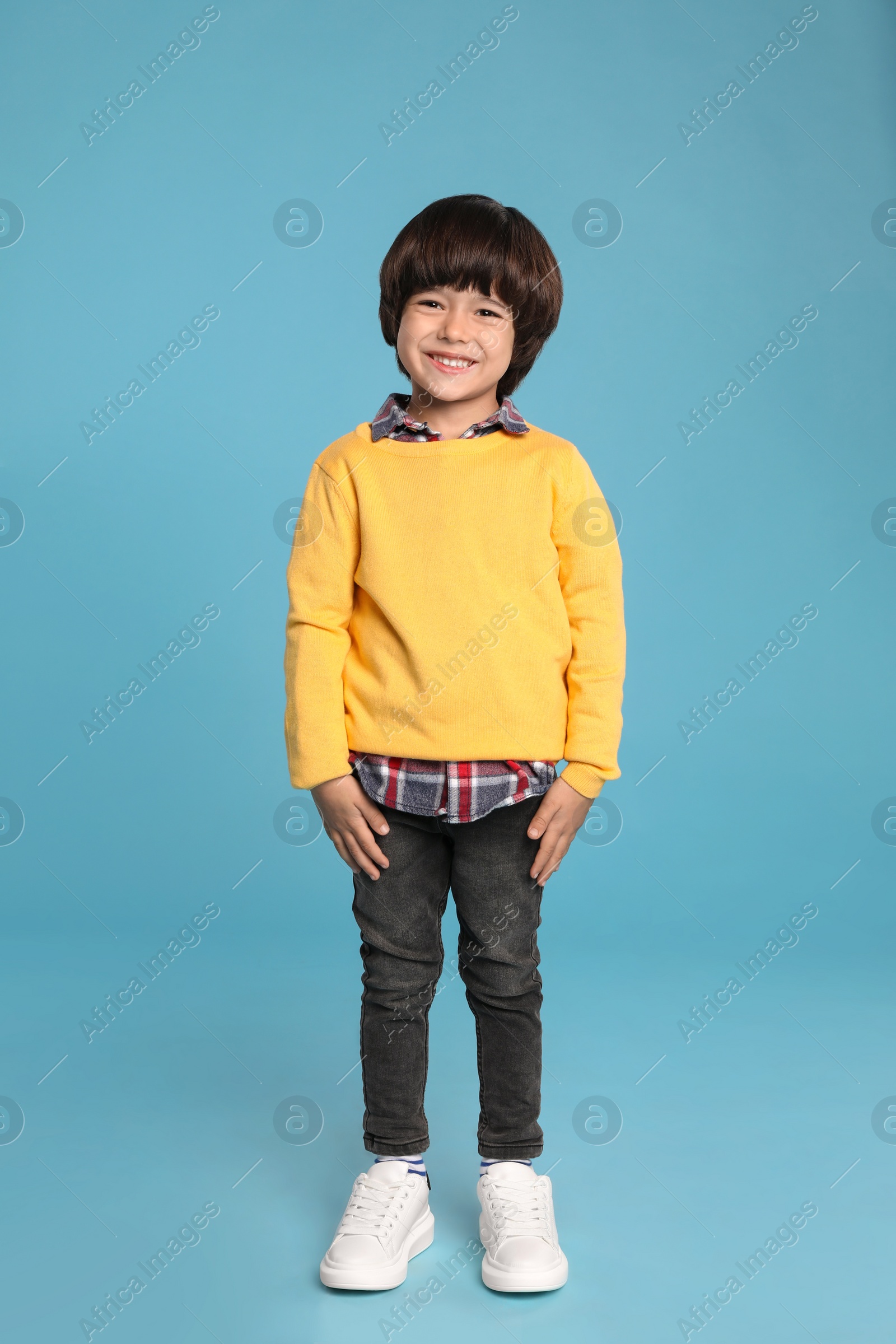 Photo of Full length portrait of cute little boy on light blue background