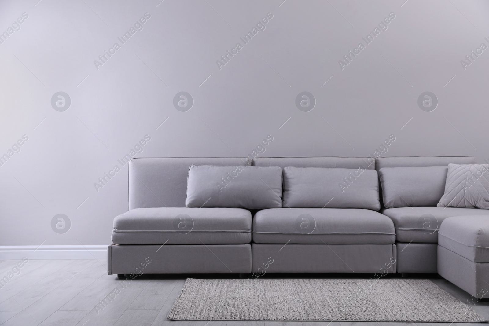 Photo of Large grey sofa in living room. Interior design
