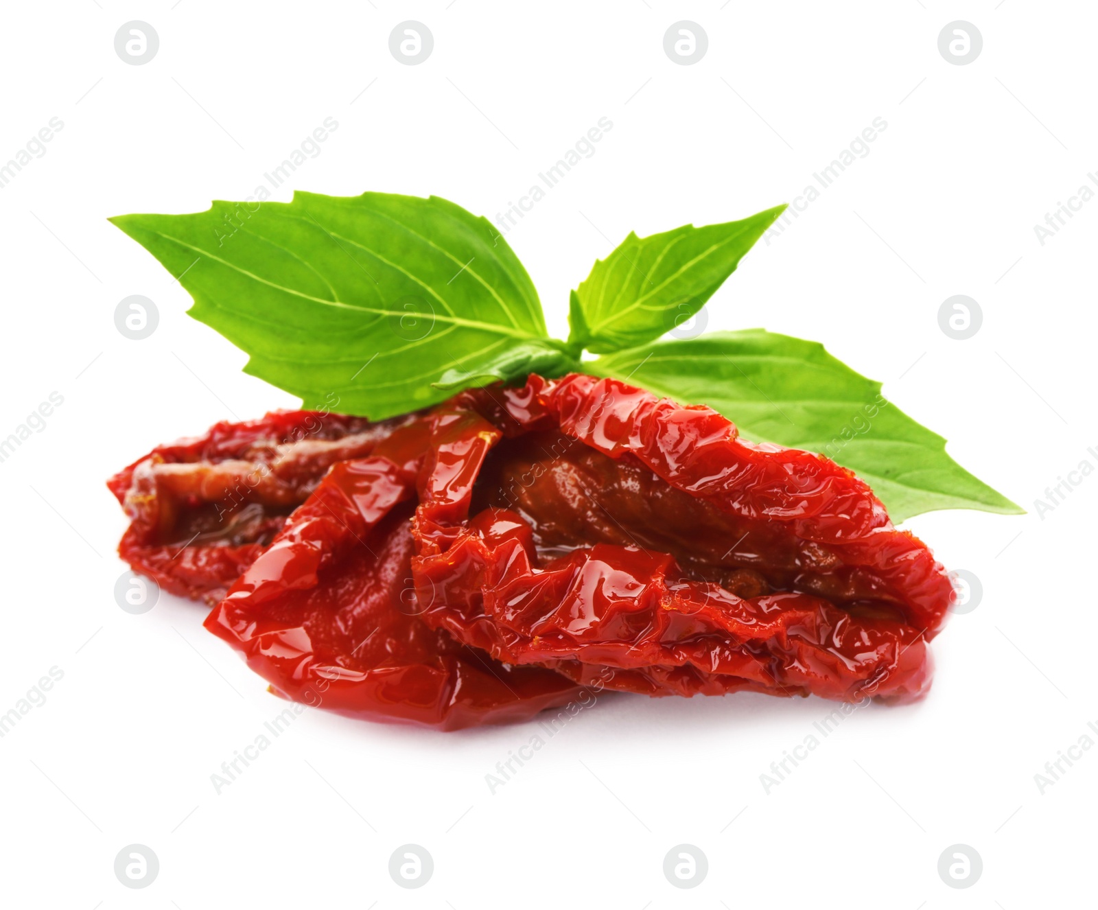 Photo of Tasty sun dried tomatoes with green leaves on white background